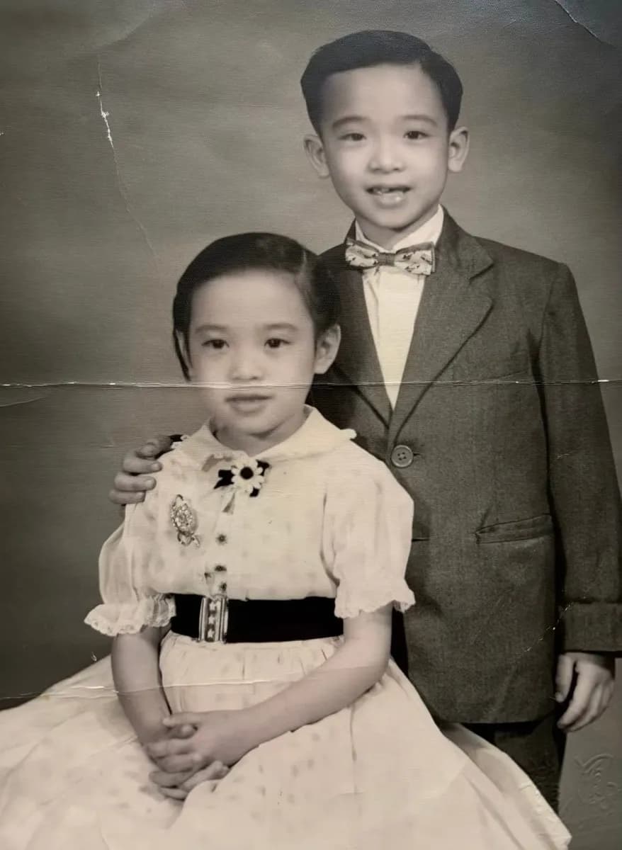 Before: black-and-white studio portrait of a young girl and an older boy in a bow tie