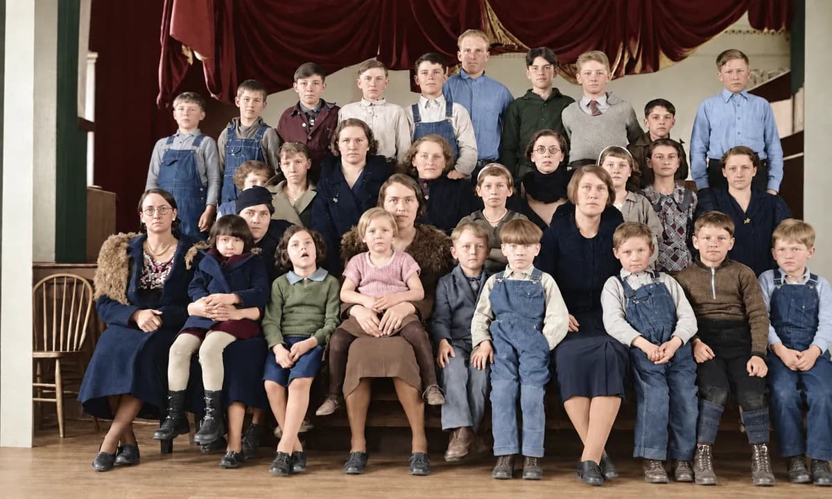 After: black-and-white group photo of a large class of children and adults on a stage