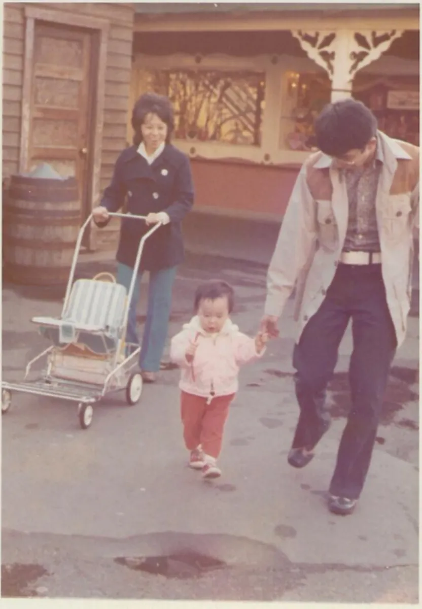 Before: faded snapshot of a family walking with a toddler and stroller at Disneyland