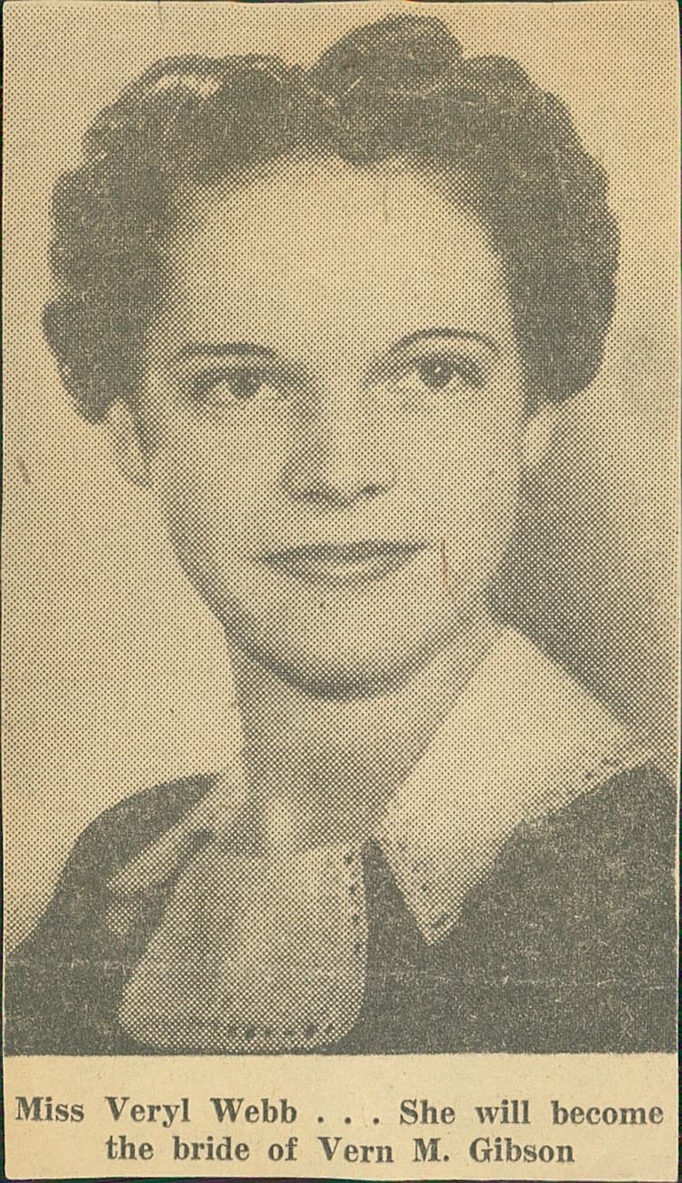 Aged sepia studio portrait with surface damage before restoration.